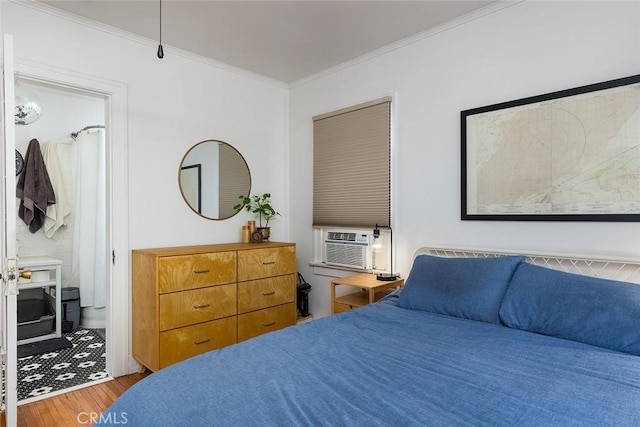 bedroom featuring crown molding, cooling unit, and hardwood / wood-style flooring