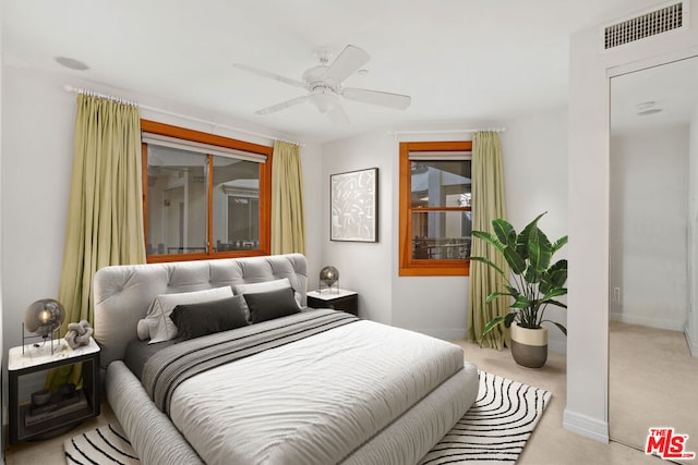 bedroom featuring ceiling fan and light colored carpet