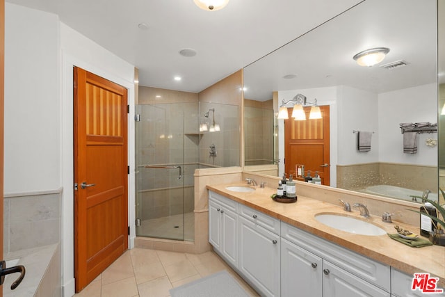 bathroom with tile patterned floors, plus walk in shower, and vanity