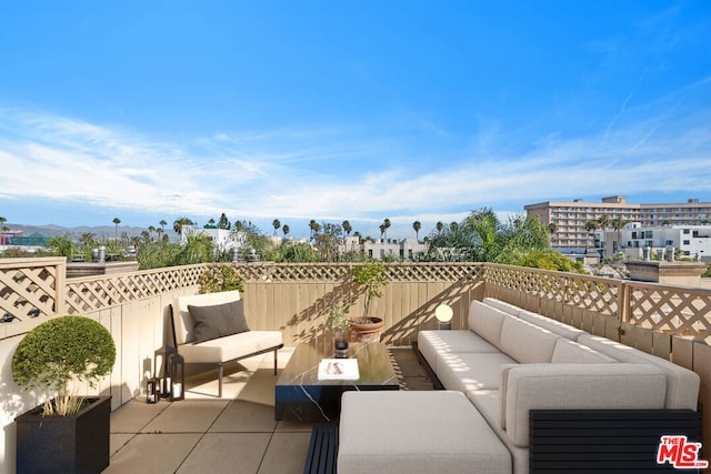 view of patio with a balcony, outdoor lounge area, and a mountain view