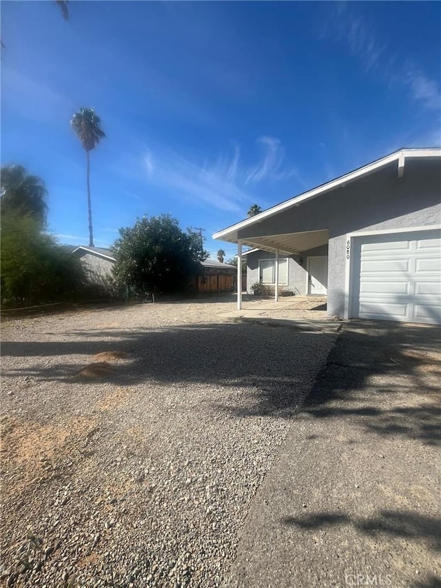 exterior space with a carport and a garage