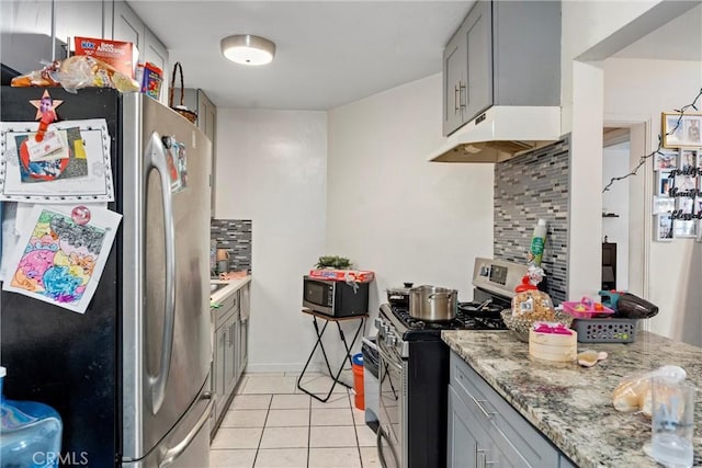 kitchen featuring gray cabinets, light tile patterned floors, appliances with stainless steel finishes, and tasteful backsplash