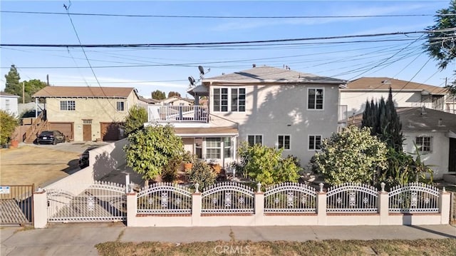 view of front of home featuring a garage and a balcony