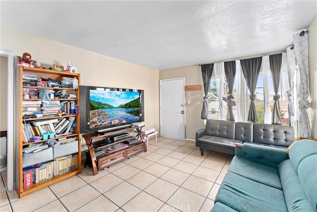 tiled living room featuring a textured ceiling