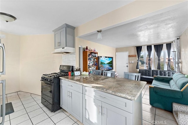 kitchen featuring gray cabinetry, light stone countertops, black range with gas cooktop, and light tile patterned floors