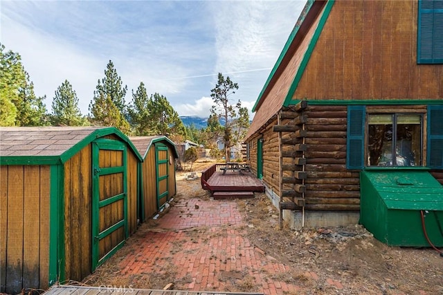 view of property exterior featuring a wooden deck