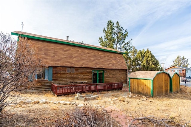 rear view of property featuring a deck