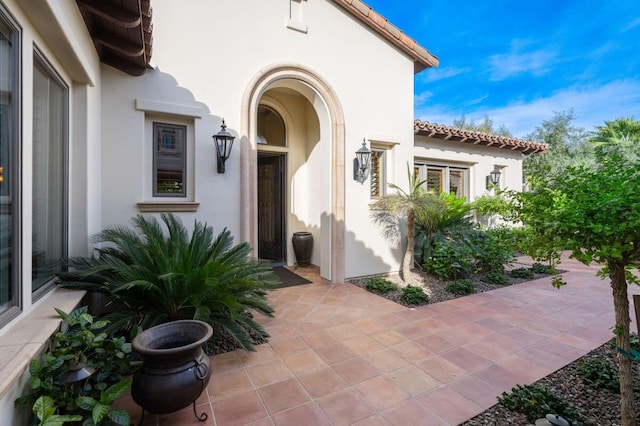 view of exterior entry featuring a patio