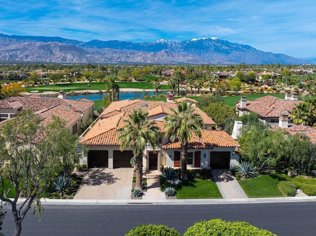 birds eye view of property with a water and mountain view