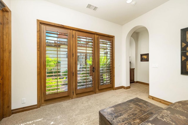 entryway featuring light colored carpet