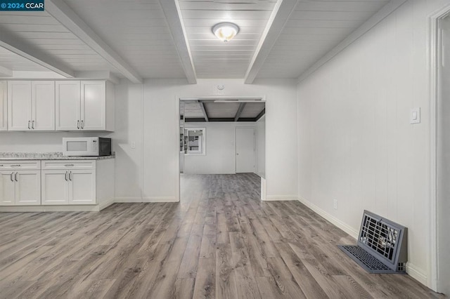 interior space with beam ceiling, wood ceiling, and light wood-type flooring