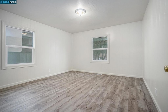 unfurnished room featuring light hardwood / wood-style floors