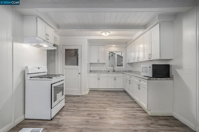 kitchen with white cabinets, light hardwood / wood-style floors, white appliances, and beamed ceiling