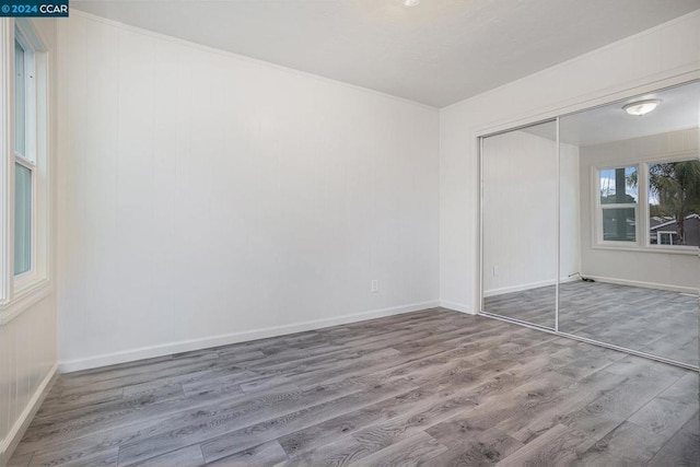 unfurnished bedroom featuring hardwood / wood-style flooring and a closet