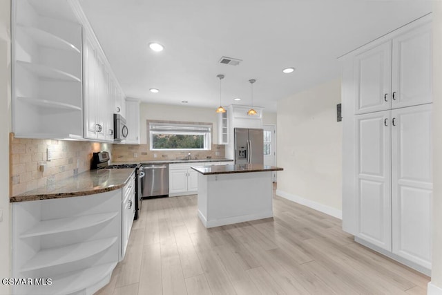 kitchen featuring appliances with stainless steel finishes, a center island, and white cabinets