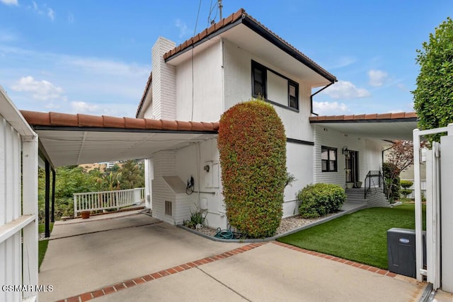 back of house featuring a carport