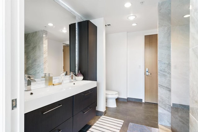 bathroom with toilet and vanity