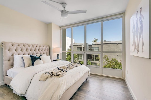 bedroom with ceiling fan and hardwood / wood-style floors