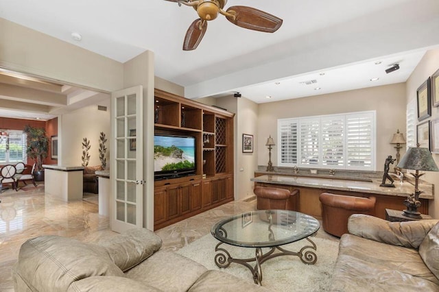 living room with ceiling fan and french doors