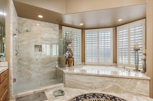 bathroom with vanity and independent shower and bath