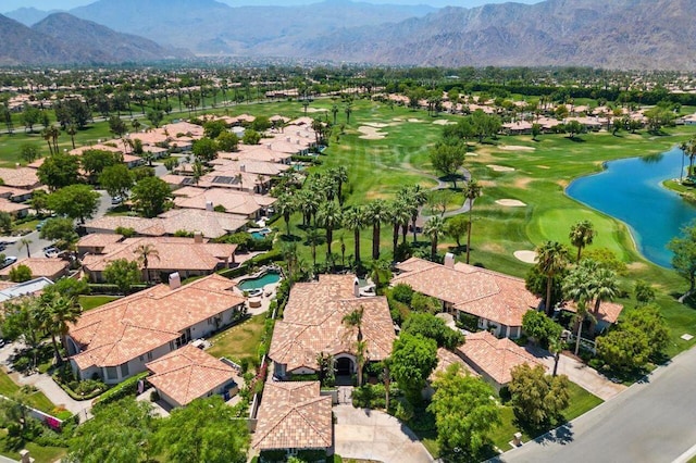 birds eye view of property with a water and mountain view