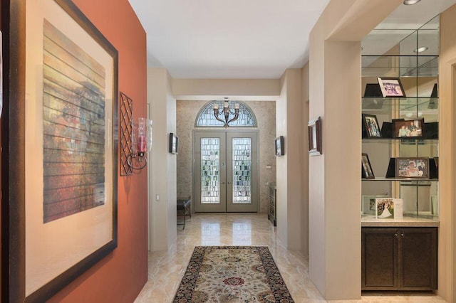 foyer entrance featuring french doors and an inviting chandelier