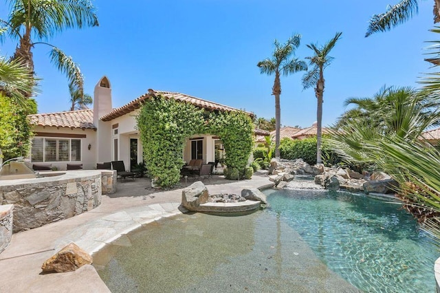 view of pool featuring area for grilling and a patio area