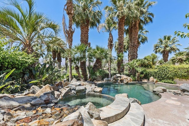 view of pool with an in ground hot tub