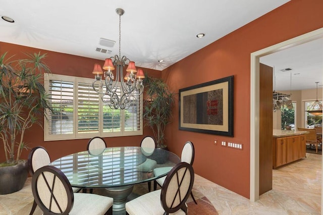 dining area with an inviting chandelier