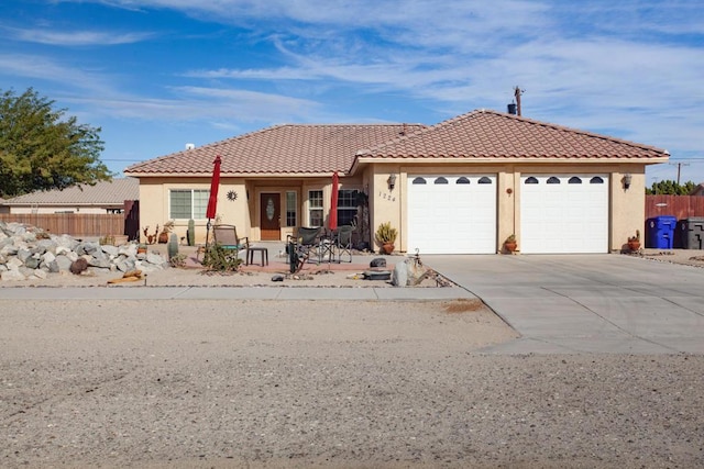 view of front of home with a garage and a patio area