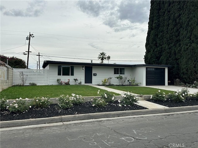 view of front of house with a garage and a front yard