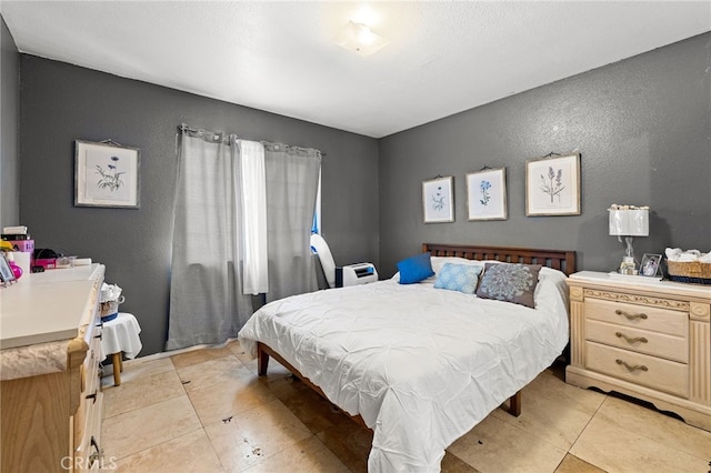 bedroom with light tile patterned floors