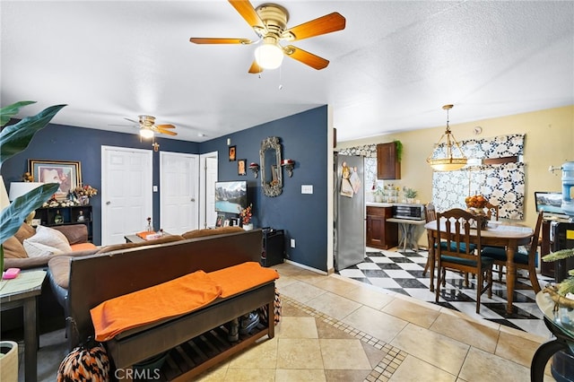 tiled living room with a textured ceiling and ceiling fan