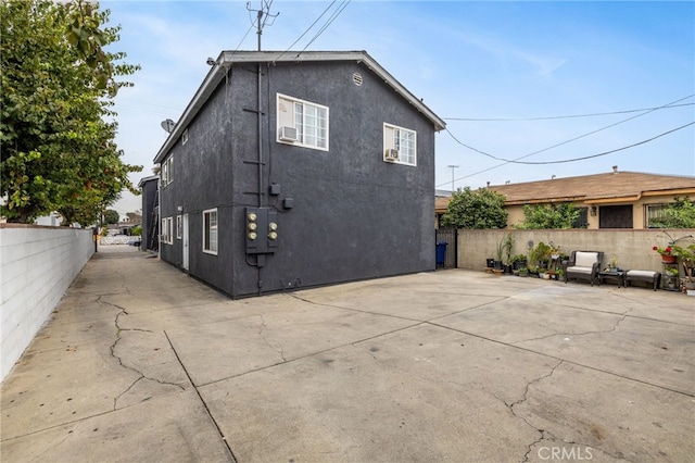 view of property exterior with a patio