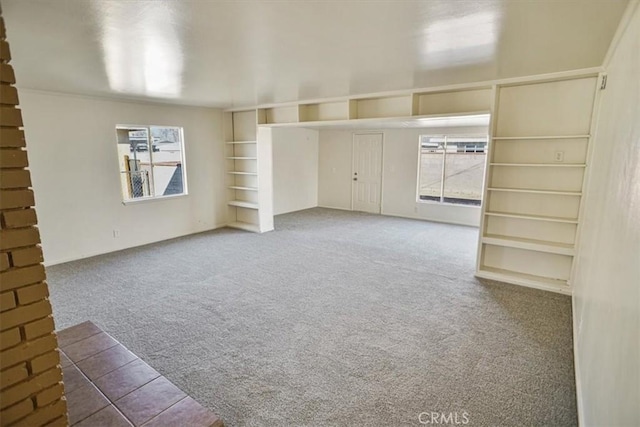 unfurnished living room featuring carpet flooring