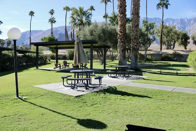 view of home's community with a lawn and a mountain view