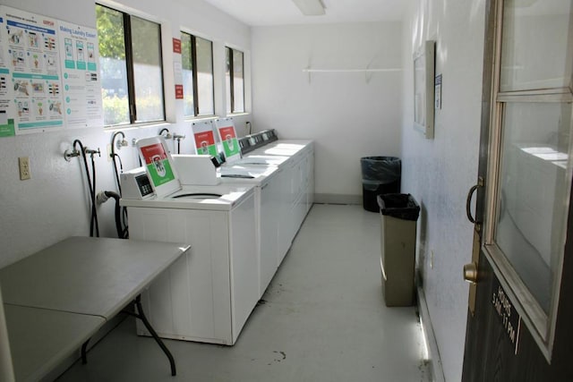 clothes washing area featuring washing machine and dryer and electric panel