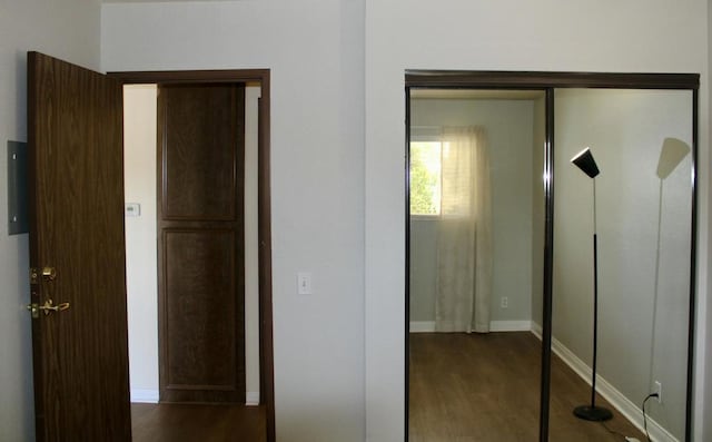 corridor featuring dark hardwood / wood-style flooring