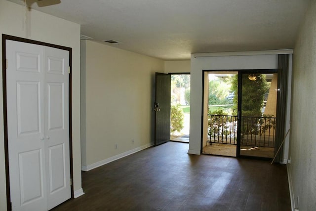 empty room with dark wood-type flooring