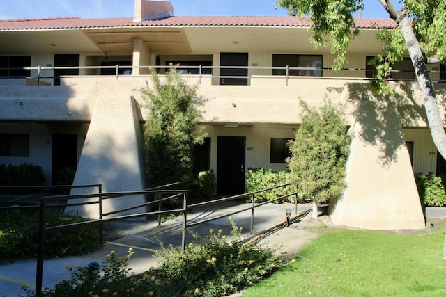 rear view of property with a balcony