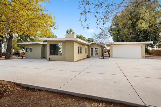 single story home featuring a garage and french doors