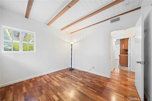 spare room featuring wood ceiling, hardwood / wood-style floors, and lofted ceiling with beams