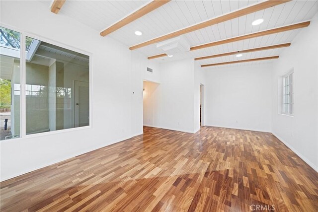 unfurnished living room featuring wood ceiling, hardwood / wood-style flooring, and beamed ceiling