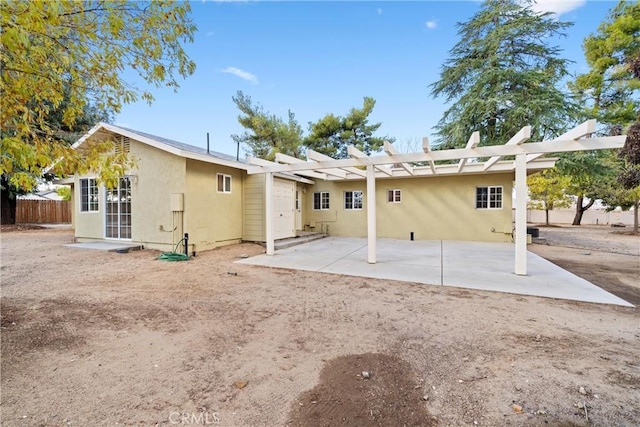 back of property with a pergola