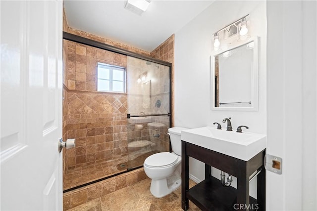 bathroom featuring toilet and walk in shower