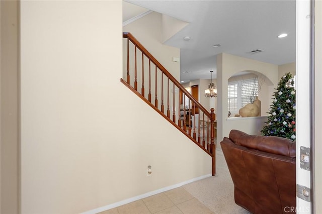 staircase featuring carpet flooring, crown molding, and a notable chandelier