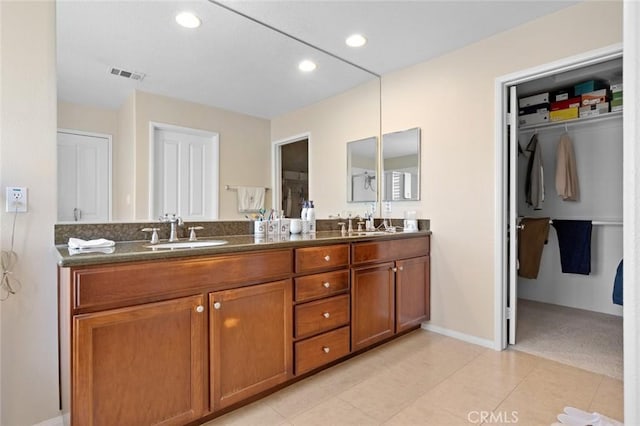 bathroom featuring tile patterned flooring and vanity