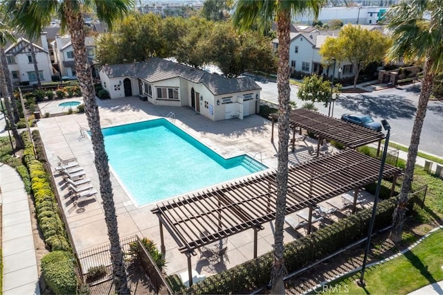 view of pool featuring a community hot tub, a pergola, and a patio