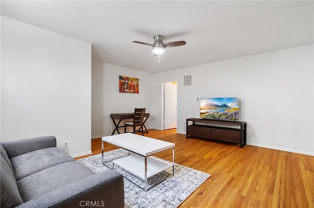 living room featuring wood-type flooring and ceiling fan