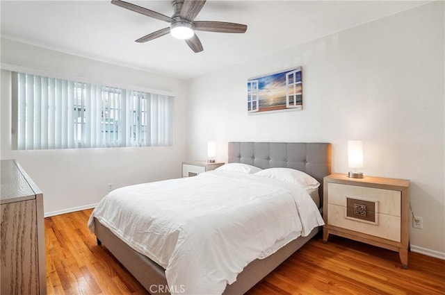 bedroom with ceiling fan and light hardwood / wood-style flooring